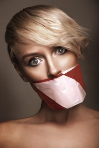 Woman's mouth sealed with a warning tape