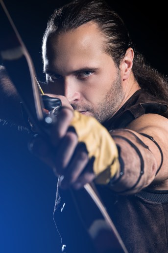 Young man with bow and historical costume