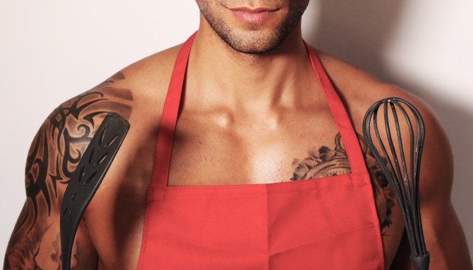 sexy man holding a whip for cooking